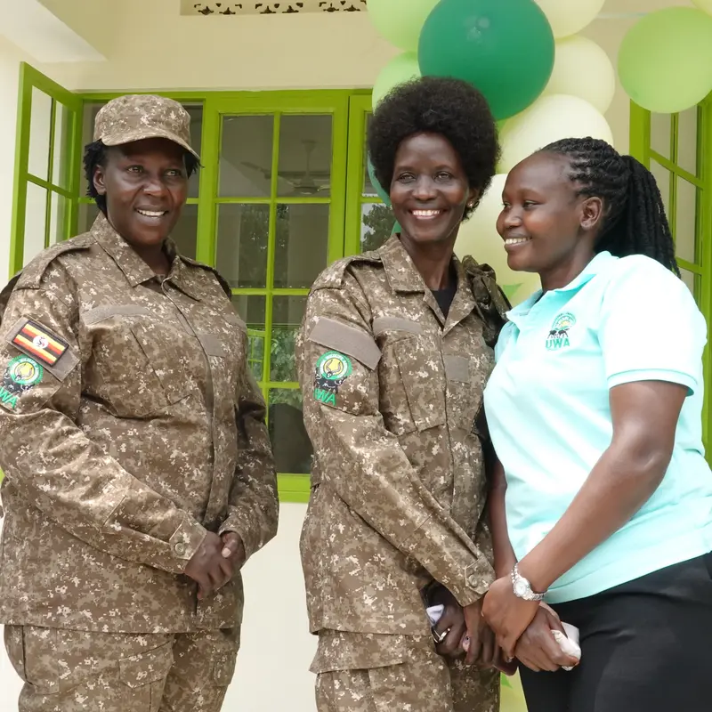 Drei Frauen vor dem neuen Education Center im Kibale-Nationalpark. , darunter zwei Rangerinnen der Uganda Wildlife Authority.